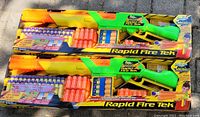 Two Buzz Bee Rapid Fire Tek air blaster toy guns in original packaging with bonus 20 foam shells and darts each.