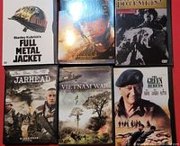 Six unopened war-themed DVDs arranged in two rows, showing front covers and spine titles clearly