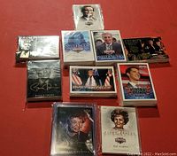 Complete set of sealed trading card packs featuring various political figures laid out on a flat surface.