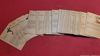 Pile of the vintage trading cards showing mostly the back sides with printed text and numbering for each card.