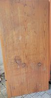 Top side of the oak table top showing wood grain with stains and water marks.