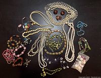 Full assortment of mixed bead and stone jewelry including necklaces, bracelets, and loose beads