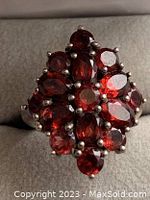 Top view of the ring showing the red gemstone cluster setting in sterling silver.