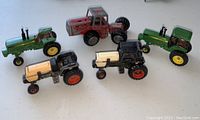 Photo showing all five toy tractors from above with details visible