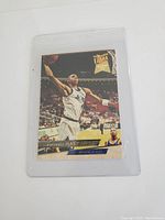 Front of Anfernee Hardaway rookie basketball card with player dunking in Orlando Magic uniform, Fleer Ultra branding visible.