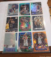 Front side of nine basketball cards featuring players Magic Johnson, Lonzo Ball, Donovan Mitchell, Kevin Garnett, Brook Lopez with various holo and rare insert effects.