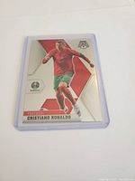 Front side of the Cristiano Ronaldo soccer trading card showing player in Portugal uniform with mosaic design background