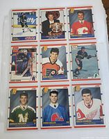 Front of nine hockey rookie cards laid in a 3x3 grid inside a plastic sleeve