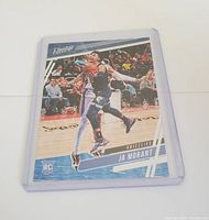 Front side of Ja Morant rookie card in protective sleeve, showing in-game action and Prestige logo.