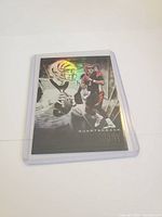 Front of Joe Burrow rookie football card with refractor holographic effect, showing Joe Burrow in Cincinnati Bengals uniform and black and white portrait.