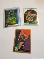 Front of 3 Larry Bird basketball cards showing different card designs and images.