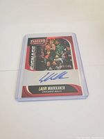 Front side of Lauri Markkanen basketball card showing numbered autograph and in-game photo