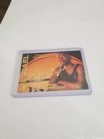 Front of Michael Jordan special event basketball card in protective sleeve showing Jordan holding basketball with gold and black design.