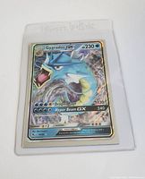 Front of the Gyarados GX full art Pokémon card showing artwork, HP, attack details, and holographic shine within a plastic protective sleeve.