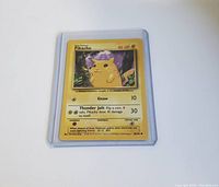 Front view of Base Set Pikachu Pokémon card inside protective sleeve showing card details and image.