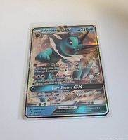 Front view of Vaporeon GX full art holographic Pokemon card showing artwork, HP, abilities, and holographic finish.
