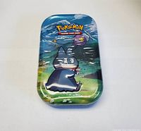 Front view of the Pokémon tin featuring Snorlax art and Pokémon Trading Card Game logo.