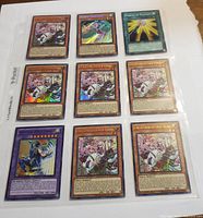 Front side of 9 Yu-Gi-Oh cards including holo and 1st edition cards.