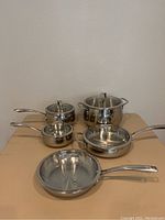Full view of the stainless steel cookware set showing pots, saucepans, skillets with lids, and the steamer insert.