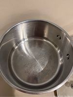 Interior of the stainless steel saucepan showing scratches and use marks