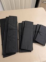 Black folded fabric drawer dividers in three sizes stacked on a table