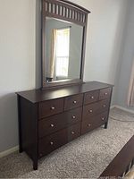 Full view of the dresser showing nine drawers and the dark brown finish