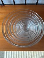 Top view showing the nested set of 9 clear glass mixing bowls stacked inside each other.