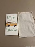 Photo of the closed travel journal showing cover design and muslin bag beside it.