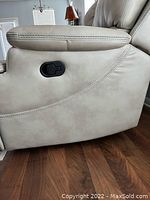 Side view of left armrest and manual recline lever in closed position