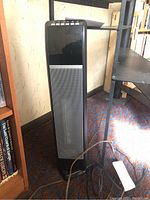 View of Hunter digital ceramic heater showing black and metallic silver exterior with control buttons at top.
