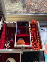 Jewelry box open at window ledge showing all items laid out
