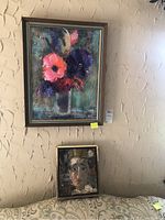 Both paintings hanging on wall above couch showing scale and framing