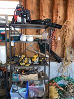 Garage shelf overview showing Echo blower, planters, drills and other tools