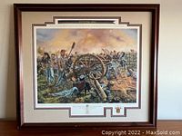 Framed large print depicting a Civil War battle scene with soldiers and a cannon labeled 'Antietam' by Rick Reeves.