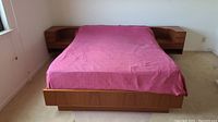 Front view of full bed frame with pink comforter