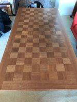 Full top view of teak coffee table showing checkerboard wood pattern and overall rectangular shape.