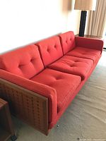 Angled front view of full sofa showing cushions and frame