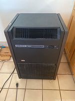 Full view of NSA 7100 air purifier showing top front vent, power switch, and general shape.