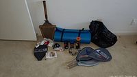 Photo of the lot showing rackets, yoga mat, gloves, goggles, skip rope and accessories