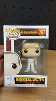 Front view of Hannibal Lecter Funko Pop figure in windowed box showing sticker number 787 and minor damage on top left box corner