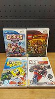 Front view of the four Nintendo Wii game cases: Circus Games, LEGO Indiana Jones, SpongeBob Boating Bash, NHL 2K9.