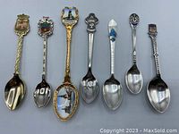Photo showing all 7 assorted vintage souvenir spoons side by side for size and detail comparison.