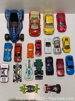 Top-down view of the 20 assorted small toy cars in various colors and designs.
