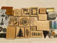 Layout of many wooden mounted rubber stamps with detailed designs and three ColorBox ink pads to right.