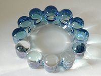 Top-down view showing the circular bubble ball design and blue tint on heavy glass ashtray.