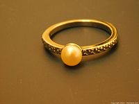 Top angle photo showing the pearl solitaire with beaded band detail.