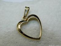 Close-up of the polished open heart pendant showing the heart shape and bail.