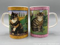 Pair of Dunoon Gallery Cats fine bone china mugs showing cat images with colorful scenic backgrounds and crackled border design, one with black and white and tabby cats, the other with tuxedo cats.