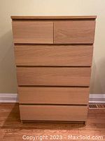 Front view of the six drawer white stained oak veneer dresser in good condition, drawers closed.