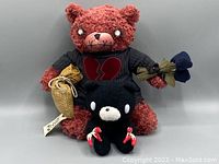 Front view of both bears showing Edwin Morose in larger red fuzzy texture and Gloomy Bear small black with red claws